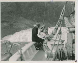 Image of Miriam on port rail looking at glacier